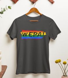 "WEPA! Express your Puerto Rican heritage and showcase your pride with this unique and meaningful unisex t-shirt. Whether you're attending a pride event, exploring your cultural roots, or simply adding a vibrant touch to your everyday outfits, this shirt is a statement piece that will make heads turn and spread joy wherever you go.  Available in a range of sizes, our Rainbow \"WEPA!\" T-Shirt is designed to fit all genders comfortably. It also makes a thoughtful gift for your Puerto Rican friends, family, or loved ones who appreciate colorful expressions of identity and heritage. \"WEPA!\" is not just a word but a contagious feeling of excitement and celebration. Add this joyful t-shirt to your collection today and let your vibrant spirit shine through! .: 100% Airlume combed and ringspun Pride Short Sleeve T-shirt With Letter Print, Pride Letter Print Short Sleeve T-shirt, Pre-shrunk Crew Neck T-shirt For Pride, Pride Screen Print Crew Neck T-shirt, Pride Slogan T-shirt With Short Sleeves, Pride Slogan T-shirt Short Sleeve, Rainbow Crew Neck T-shirt For Pride, Rainbow Letter Print Pride T-shirt, Rainbow Letter Print T-shirt For Pride