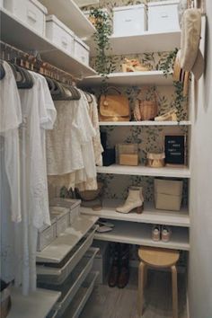 an organized closet with white shelves and drawers