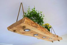 a wooden planter hanging from the ceiling