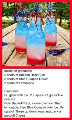 two blue and red drinks sitting on top of a wooden table next to each other