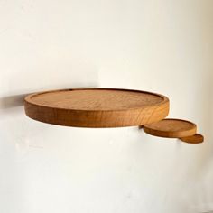 two wooden plates are hanging on the wall