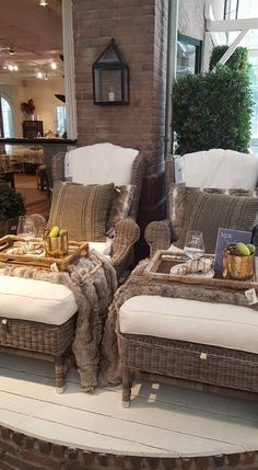 two wicker couches sitting on top of a wooden floor next to each other