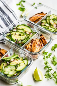 four glass containers filled with chicken and cucumber salads