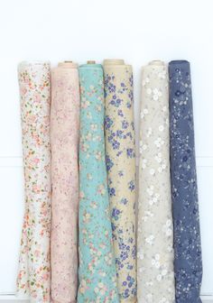 five different colored fabrics are lined up together in a row, with the words little letter on