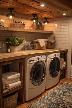 a washer and dryer sitting in a room next to a shelf with towels