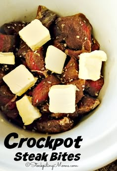 crockpot steak bites in a white bowl topped with butter and parmesan cheese