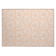 a beige rug with white sand dollars on it