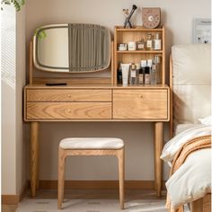 a wooden dresser with a mirror, stool and other items on top of it in a bedroom