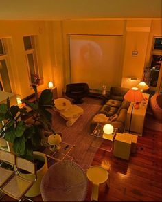 an overhead view of a living room with couches, chairs, and a projector screen