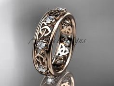 an intricately designed wedding ring with hearts and diamonds in 18k rose gold or white gold