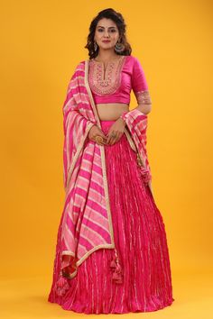 Shop a Pink gota patti embroidered set featuring silk dupatta set. It comes with a beautiful striped multicolor embroidered dupatta, pink blouse with hook closure and tie up at back. Pair it with beautiful jewelry to enhance your look. Shop online from Pure Elegance. Pink Lehenga With Gota Work, Pink Kundan Anarkali Set With Cutdana, Pink Dola Silk Anarkali Set, Pink Raw Silk Traditional Wear With Mirror Work, Pink Silk Choli With Mirror Work, Festive Silk Thread Lehenga, Silk Thread Lehenga For Diwali, Transitional Pink Saree With Mirror Work, Pink Raw Silk Choli For Navratri