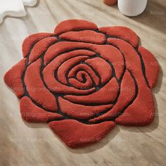 a red rose shaped rug on the floor