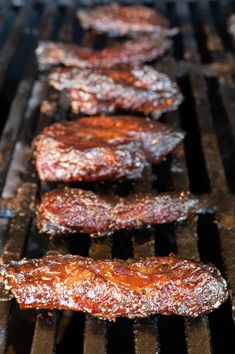 ribs cooking on the grill with sauce and seasoning