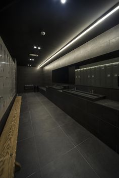 an empty public restroom with sinks and mirrors