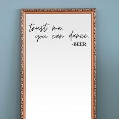 there is a mirror with writing on it and a beer in the bottom right hand corner