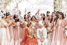 the bride and groom are surrounded by confetti as they throw them into the air