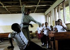 a group of young men standing next to each other in a classroom