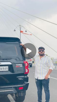 a man standing next to a black truck