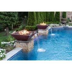 an outdoor swimming pool with fire pits in the middle