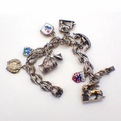 "Vintage ornate 830 silver chain bracelet decorated with 8 figural dangle charms, representing different European destinations. Some charms are accented with colorful enamel, one charm is silver-plated. This lovely bracelet is 7 1/2\" long, weighing 46.8 grams or 1.5 ozs Troy. EA3729" European Destination, Bead Bar, European Destinations, Silver Chain Bracelet, Bracelet Vintage, Tiffany And Co, Dangle Charms, Chain Link Necklace, Charm Bracelets