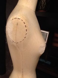 a mannequin's torso with stitches on it