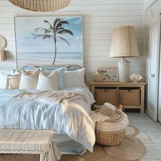 a bed with white sheets and pillows in a bedroom next to a painting on the wall