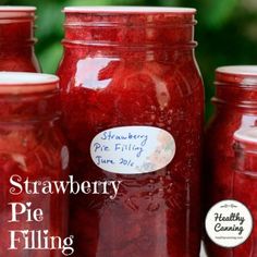 three jars filled with strawberry pie filling sitting next to each other