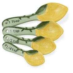 three yellow ceramic measuring spoons with green leaves on them, each measuring 1 / 2 - 3 / 4