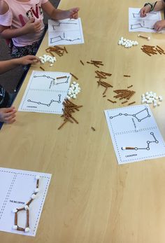 children sitting at a table working on matching objects to make their own necklaces and bracelets