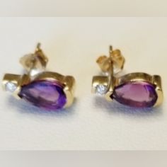 Vintage 14k Gold Amethyst Earrings W/ Cubic Zirconia Accents Stone Metal- Solid Gold Color Gold- Yellow Gold Stone(S)- Amethyst & Cubic Zirconia Stamped/Makers Markings- 14k Approximate Measurements- Cubic Zirconia Stones Approx. Size- 1mm Amethyst Stones Approx. Size- 11mm X 4mm Approx. Weight: 1.53g Condition- Used/Vintage, Has Regular Wear Stamp Maker, Amethyst Stones, Gold Stone, Amethyst Earrings, Amethyst Stone, Solid Metal, Gold Yellow, Solid Gold, Gold Color