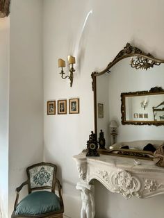 a chair and mirror in a room with white walls