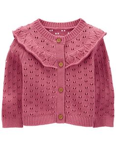 a pink cardigan sweater with an openwork design on the shoulders and collarline