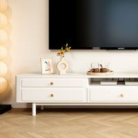 a flat screen tv sitting on top of a white entertainment center