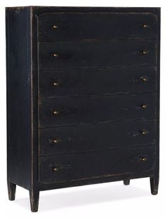 an old black chest of drawers with brass knobs