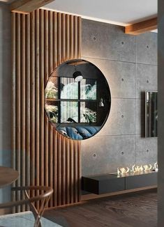 a living room with a round mirror on the wall and wood slats behind it