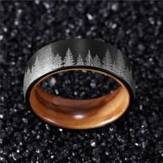 a black and silver ring with trees on it