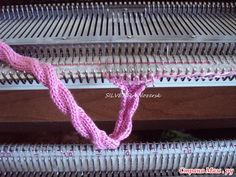 a pink ribbon is tied to the side of an old type piano with metal strings