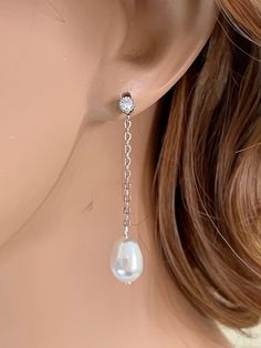 "Gorgeous, comfortable and chic, perfect for brides, bridesmaid or special someone in any occasion. These elegant earrings feature a lovely teardrop crystal ear, sterling silver post stud. Round cz stones dangle elegantly above a teardrop shape Swarovski pearl.  The pearl is available in your choice of white or ivory, light grey and dark grey. These measure approximately 1 3/4\"  inches long in total length. Shown on a life sized mannequin for reference.  These earrings comes in a gift jewelry b Sterling Silver Drop Earrings For Wedding, Elegant Silver Bridal Earrings With Pearl Charm, Elegant White Teardrop Linear Earrings, Elegant White Long Drop Pearl Earrings, Classic White Gold Linear Earrings For Wedding, Elegant Pearl White Dangle Linear Earrings, Elegant Silver Pearl Drop Bridal Earrings, Silver Long Drop Wedding Earrings, Elegant Silver Bridal Earrings With Pearl Drop