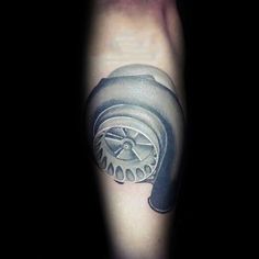 a man's arm with a black and grey tattoo on it