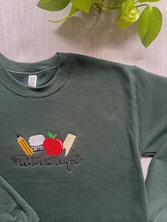 Item Overview * Handmade item *Ships worldwide from Florida *No two plants are the same  Item Details Teacher Sweatshirt, Custom Teacher Sweatshirt, Embroidered Sweatshirt, Teacher life Shirt, Teacher Valentine's gift, Personalized Teacher Colors displayed: Shirt color: Forest Green * 9.5 oz., 80% ringspun cotton, 20% polyester * Preshrunk, soft-washed, garment-dyed fabric * 1x1 rib on collar, cuffs and relaxed waistband * Forward rolled shoulder * Double-needle stitched * Sideseamed body * Set-in sleeves * Comfort Colors Please feel free to contact us with any special request! Long Sleeve School Tops With Embroidered Text, Fall School Tops With Embroidered Logo, Fall School Tops With Embroidery, Casual School Tops With Embroidered Logo, Casual Tops With Embroidered Logo For School, Embroidered Tops For School In Fall, Long Sleeve Sweatshirt With Embroidered Logo For School, Casual Tops With Embroidered Text For School, Long Sleeve Tops With Embroidered Graphics For School