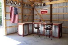 an empty garage with barstools and american flag on the wall