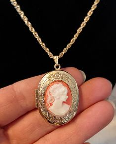 Vintage victorian style cameo necklace. Necklace is gold tone with resign cameo set on floral etched gold tone locket. Preowned Victorian Cameo Necklace, Elegant Luxury Cameo Necklace, Cheap Vintage Necklace With Oval Pendant, Gold-tone Locket Necklace, Cameo Medallion Locket Necklace, Antique Cameo Medallion Jewelry, Vintage Gold-tone Locket Necklaces, Costume Jewelry Round Pendant Locket Necklace, Costume Jewelry Necklace With Round Locket Pendant