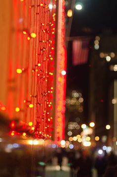 blurry image of city lights at night with buildings in the backgrouund