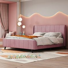 a bedroom with pink walls and wooden flooring, a large bed in the middle