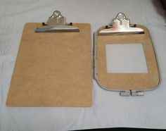 two clipboards with metal clips attached to them