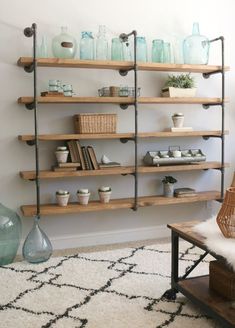 a living room filled with lots of shelves next to a wall mounted shelf full of vases