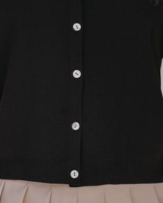 True to Size 80% Polyester and 20% Spandex Hand Wash Cold. Dry Flat Collared Short Sleeves Ribbed Edges High Quality Fabrication Front Button Closures Not Lined A polo never goes out of style! Our Sinclair Short Sleeve Button Down Polo Top comes in a black knit with a collar and ribbed edges. This preppy top has front button closures and is made in a high quality fabric. Styled with the Michaela Hoops. Mica Chain Choker Necklace. Lainey Faux Leather Backpack. Saxon Cotton Blend Pleated Tennis Skirt. and Common Thread Sneaker.---SIZE AND FIT---Model is Wearing a Size Small. Height is 5'9". Bust is 32". Waist 24.5". and Hips 34" Size XS: Length measures 20" from shoulder to hem with a 36" bust Size S: Length measures 22" from shoulder to hem with a 38" bust Size M: Length measures 23" from s Black Button-up Cardigan With Button Cuffs, Black Button-up Cardigan With Button Closure, Black Button-up Cardigan, Black Buttoned Cardigan For Everyday, Black Cardigan With Buttons For Everyday, Black Fitted Cardigan With Buttons, Fitted Black Cardigan With Buttons, Black Fitted Cardigan With Button Closure, Fitted Black Cardigan With Button Closure