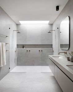 a large bathroom with two sinks and mirrors