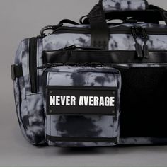 a black and white duffel bag with never average sticker on the front pocket