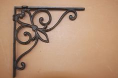 a decorative iron shelf bracket on a wall